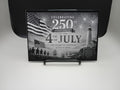 Engraved photo celebrating 250th anniversary of the 4th of July with American flag and lighthouse design.