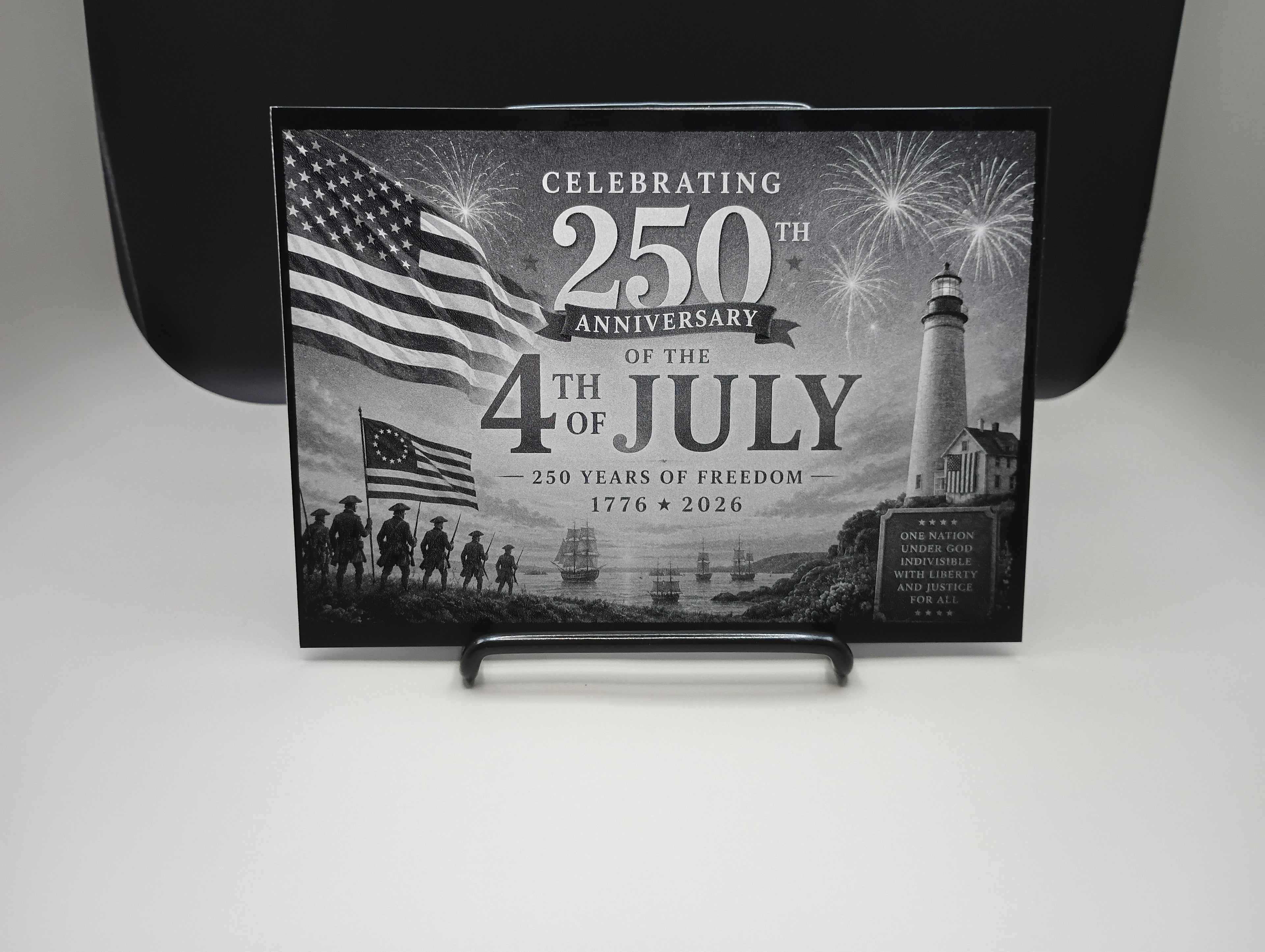 Engraved photo celebrating 250th anniversary of the 4th of July with American flag and lighthouse design.