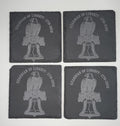 Four slate coasters with engraved eagle and bell design on a white background