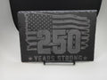 Decorative plaque with American flag and '250 Years Strong' text on a stand.