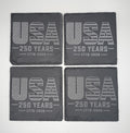 Four dark gray coasters with 'USA 250 Years 1776-2026' text on a white background