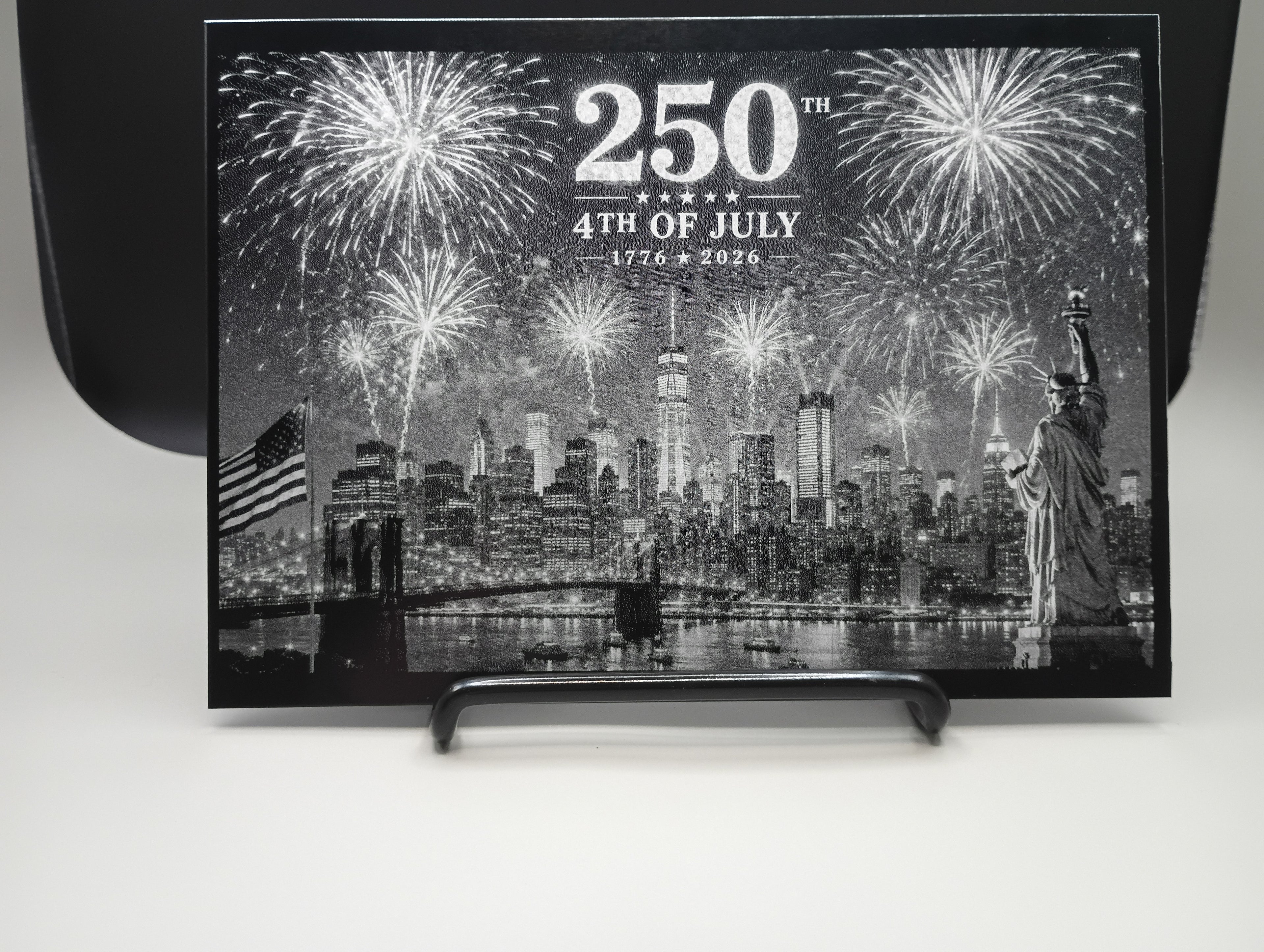 Decorative plaque with fireworks and cityscape design celebrating the 250th anniversary of the 4th of July.