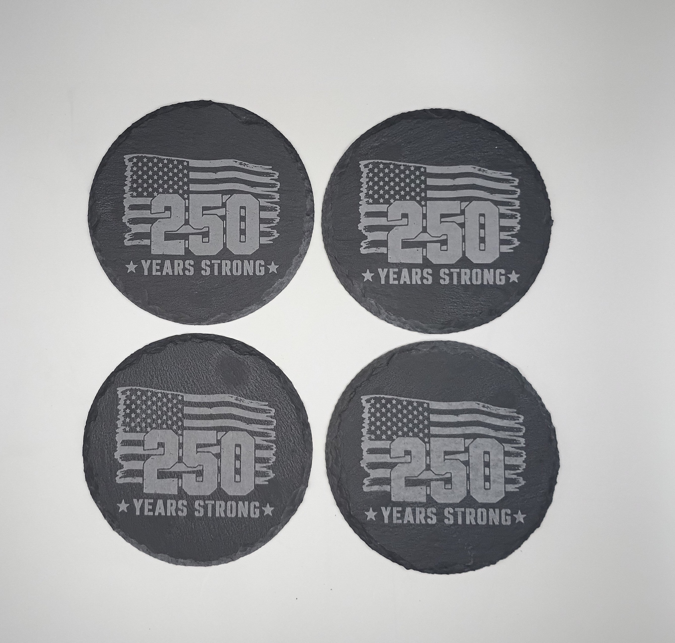 Four black coasters with '250 Years Strong' text and American flag design on a light gray background.